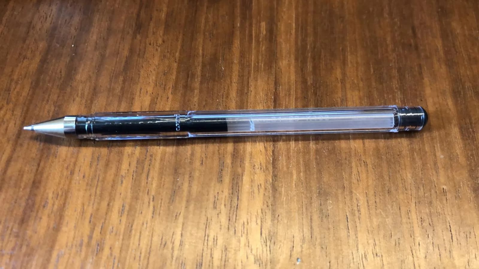 Pen photographed with a phone on a table in natural light, no styling